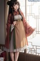 A woman in a traditional chinese dress standing in front of a window.